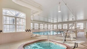 A large indoor swimming pool with a hot tub, surrounded by lounge chairs and a staircase. - Country Inn & Suites by Radisson, Elk Grove Village/Itasca (Elk Grove Village)