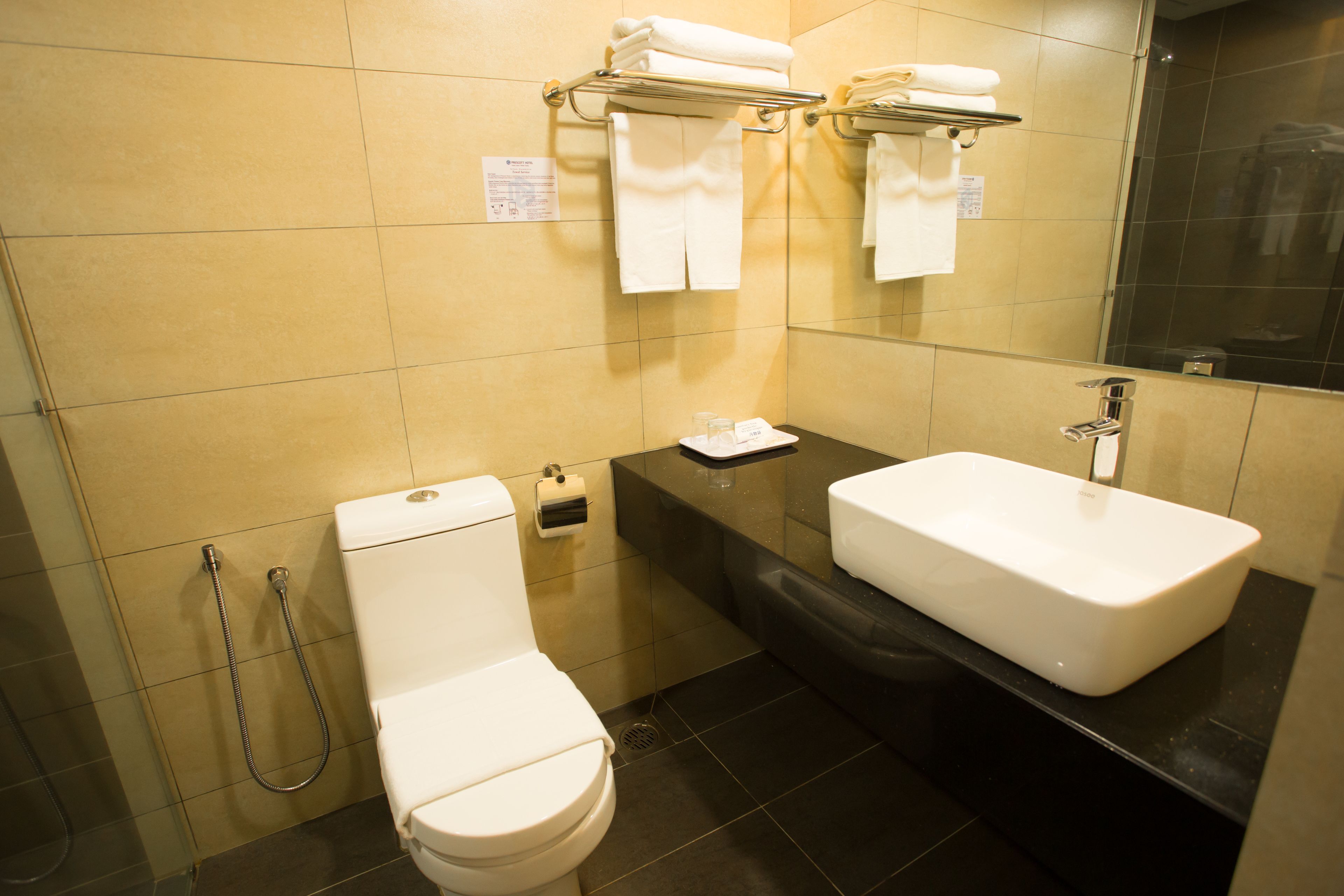 A bathroom with a toilet, sink, and shower.