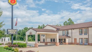 A motel with a covered outdoor area, an indoor pool, and a Super 8 sign. - Super 8 by Wyndham Vincennes (Vincennes)
