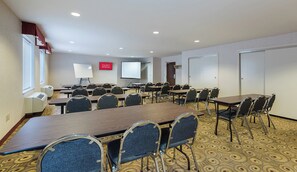 A conference room with multiple tables and chairs, a whiteboard, a projector screen, and air conditioning units. - Red Roof Inn Etowah - Athens, TN (Etowah)
