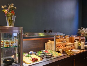 A buffet with various food items, including cheeses, fruits, and pastries. - Classik Hotel Antonius (Cologne)