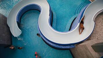 Enjoy a refreshing swim in the pool with a fun, curved slide.