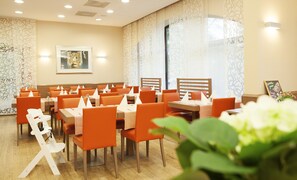 Enjoy dining in style with comfortable seating for groups, elegant table settings, and a vibrant atmosphere.