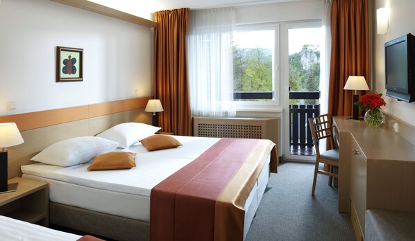 Enjoy a restful stay in this stylish room featuring a comfortable bed, desk, and TV.
