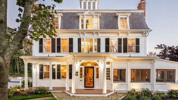 A large, two-story house with a central entrance, large windows, and a well-maintained lawn. - Chapter House (Yarmouth Port)