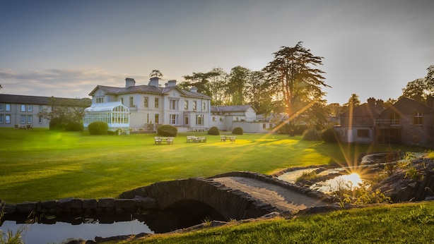 A large estate with a well-maintained lawn, a stone bridge, and a greenhouse. - Boyne Valley Hotel - Bed & Breakfast Only (Drogheda)