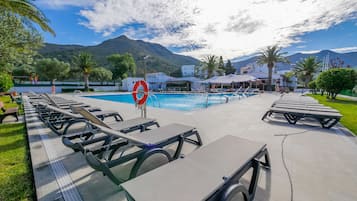 Seasonal outdoor pool, open 11:00 AM to 7:00 PM, pool loungers
