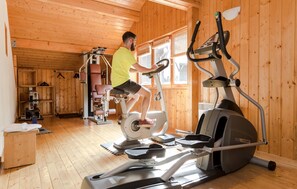 A wooden-paneled room with a treadmill and exercise equipment. - Odalys Résidence Les Chalets d'Evian (Evian-les-Bains)