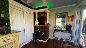 A reception area with a wooden desk, a 'Welcome' sign, a 'Sorry' sign, and a mirror with a 'Fort Fright' poster. - American Boutique Inn - Lakeview (Mackinaw City)