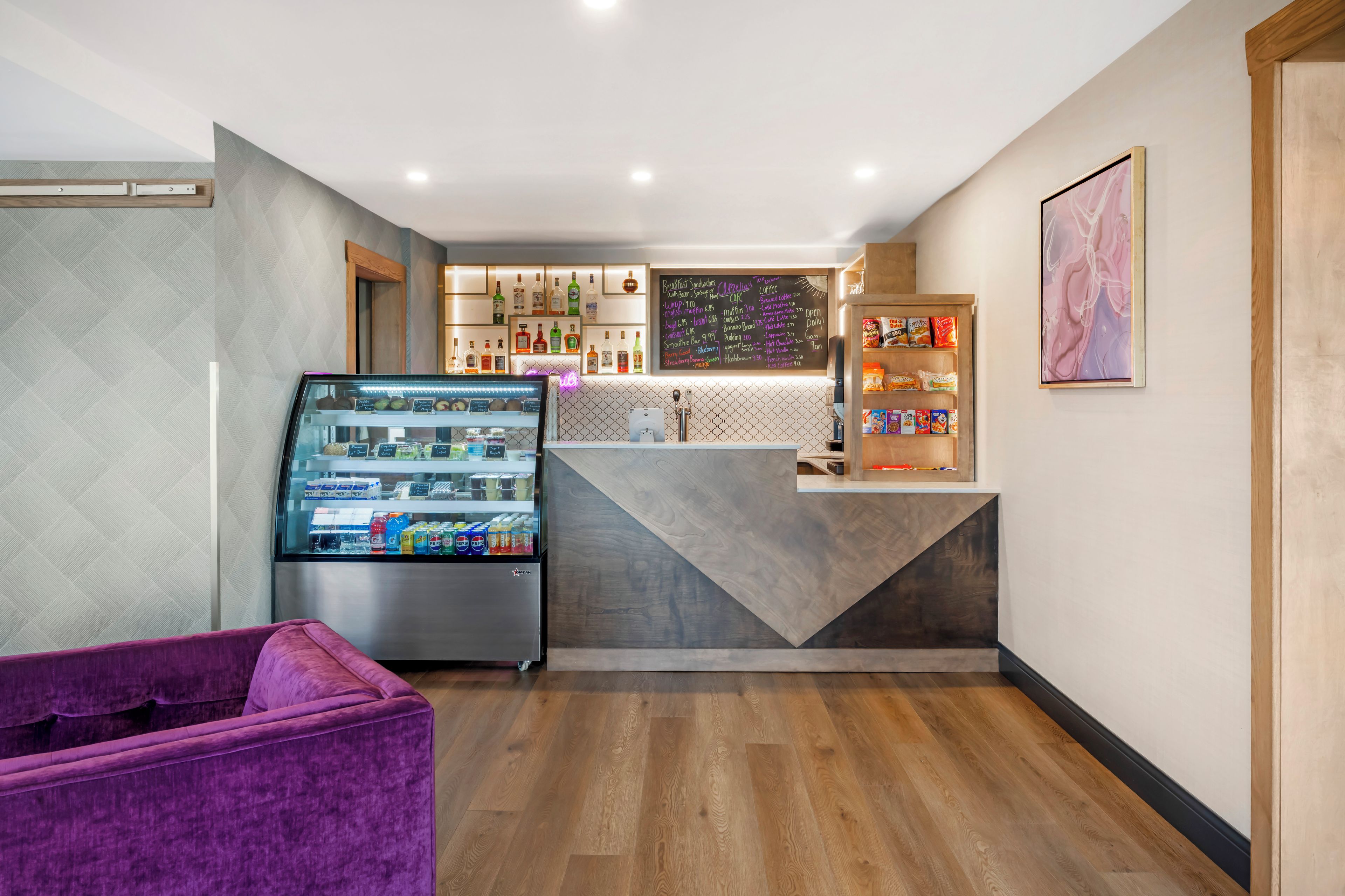 A modern interior with a vending machine, a seating area, and a counter with various items.