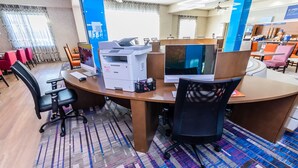 A modern office space with a large desk, multiple computer monitors, and office chairs. - Holiday Inn Express & Suites Houston East, by IHG (Houston)