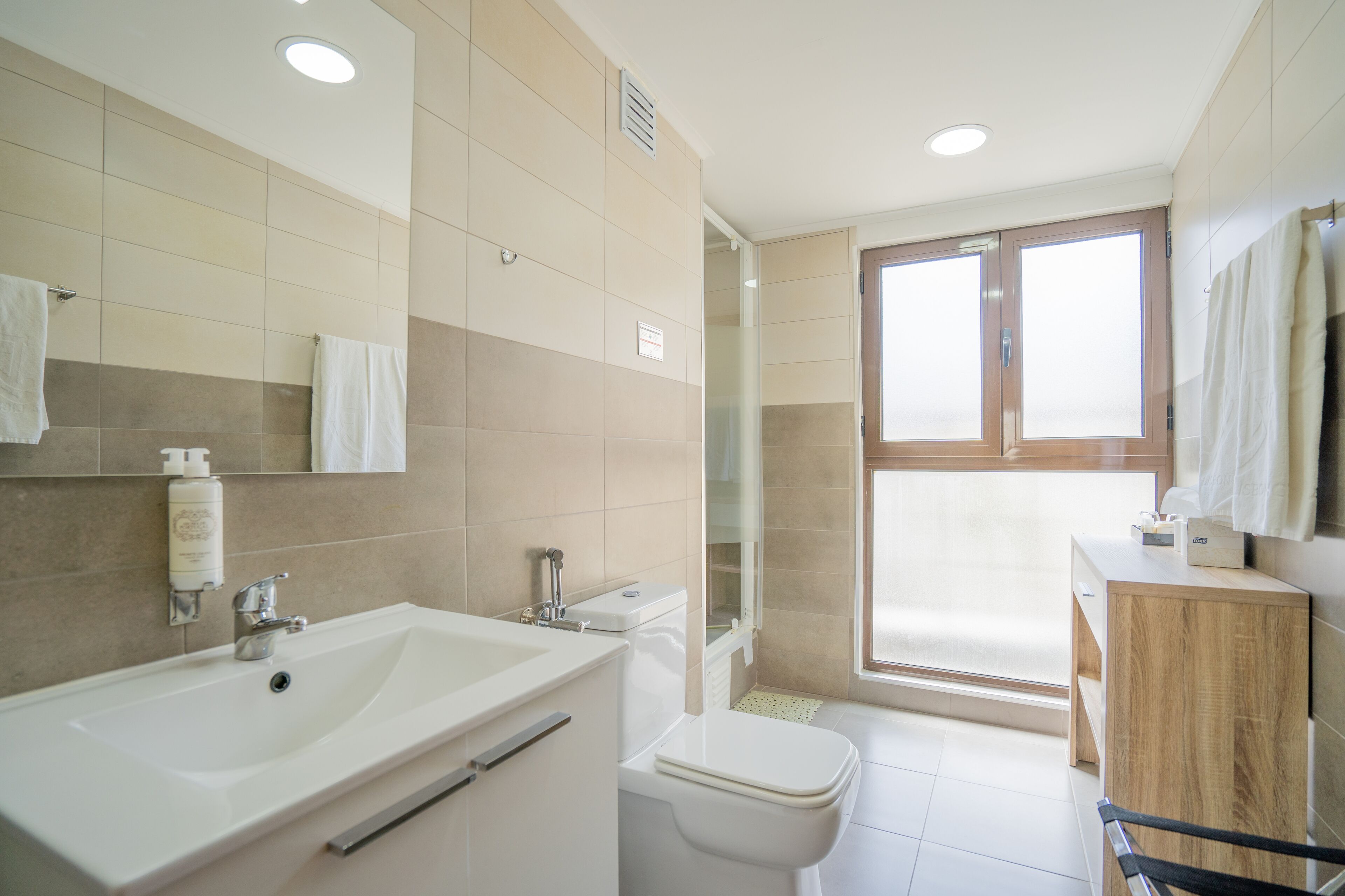 rainfall showerhead, designer toiletries, hair dryer, towels