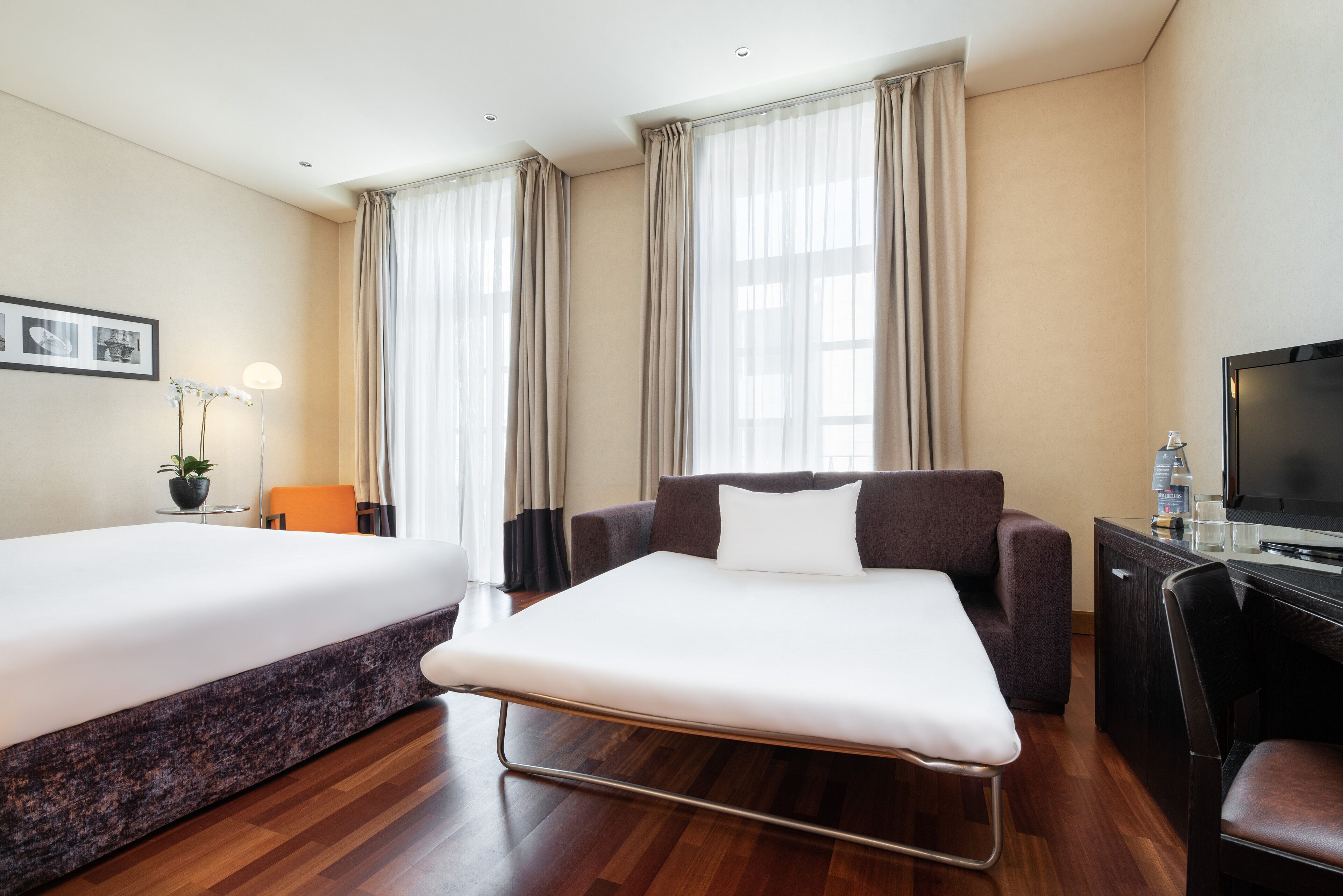 family room | 1 bedroom, minibar, in-room safe, desk