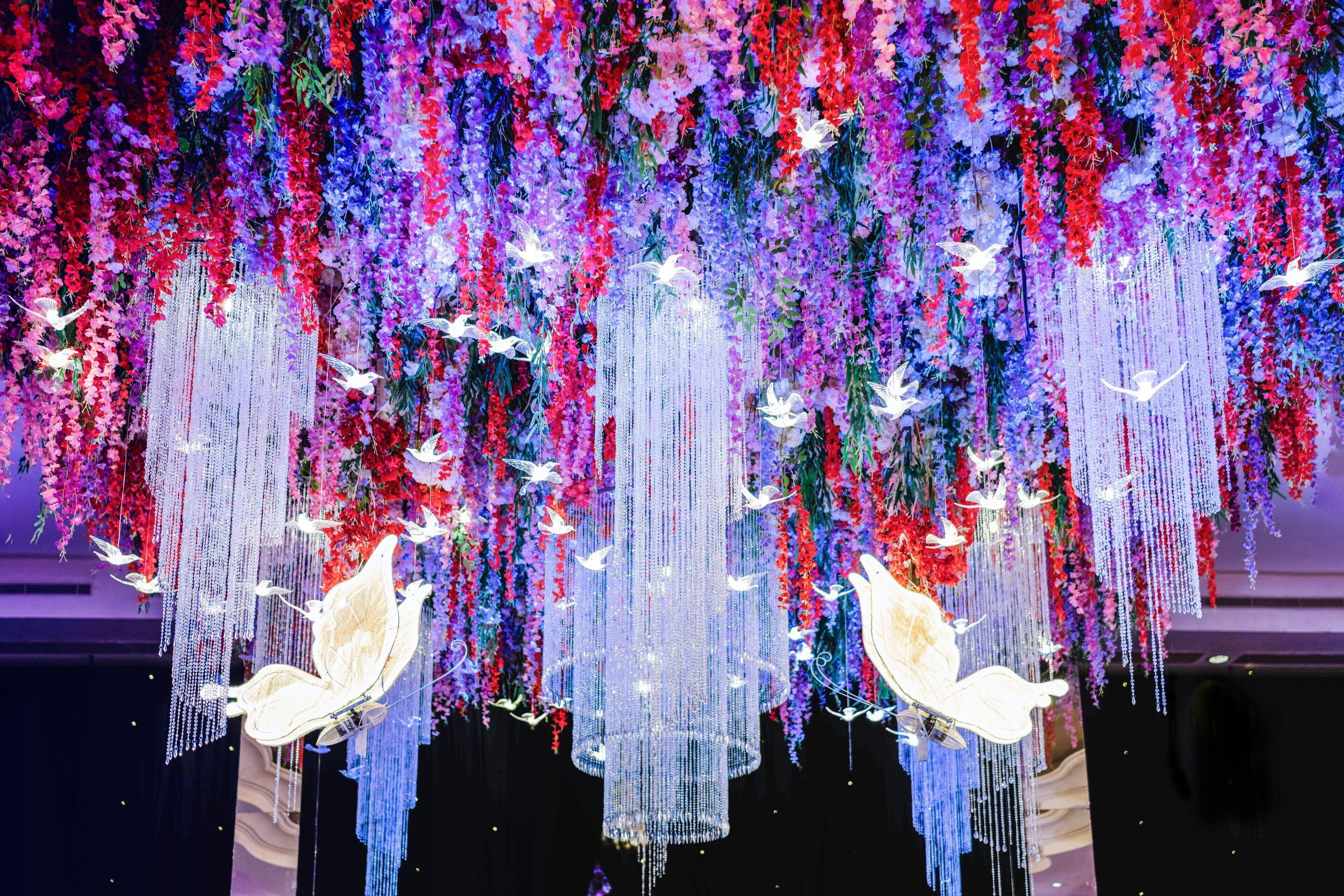 A ceiling with hanging floral arrangements and decorative elements.