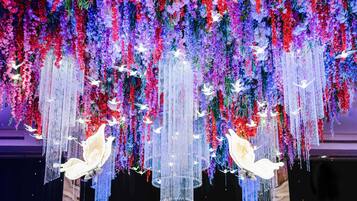 A ceiling with hanging floral arrangements and decorative elements.