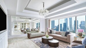 A spacious living room with a city view, a chandelier, and modern furniture.