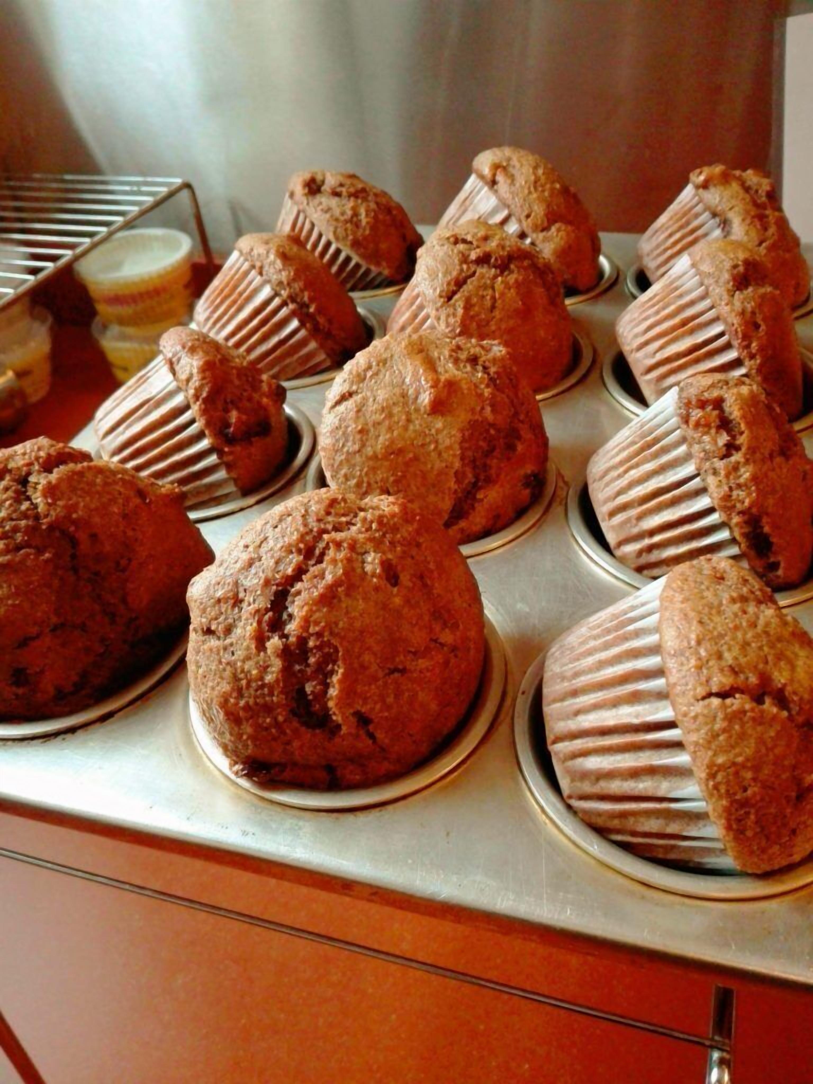 A bakery display with muffins in paper liners.