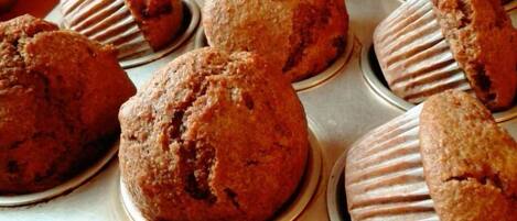 A bakery display with muffins in paper liners.