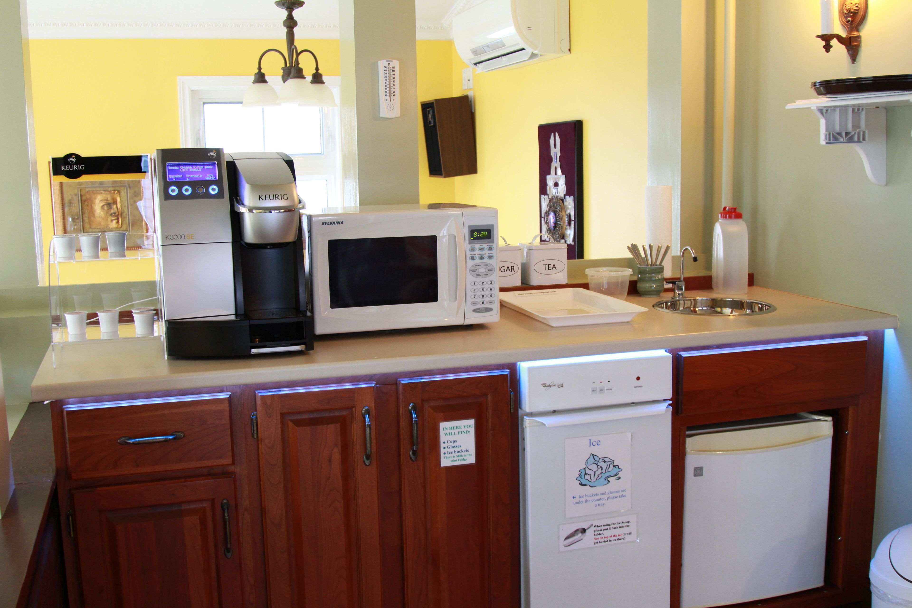 A kitchen with a coffee maker, microwave, and dishwasher.