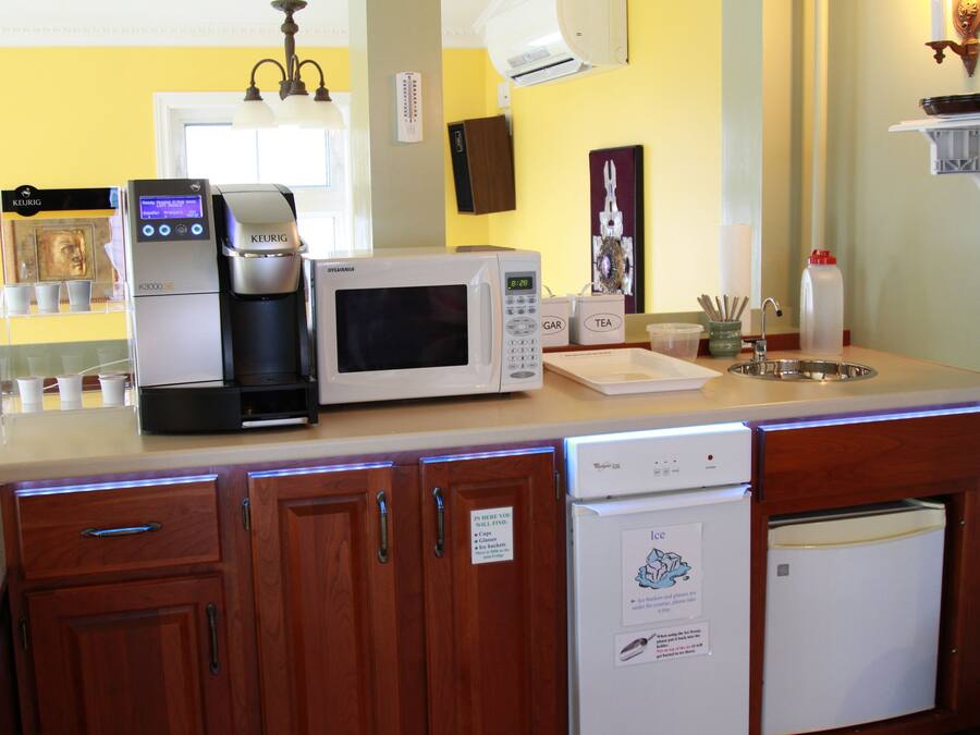 A kitchen with a coffee maker, microwave, and dishwasher.