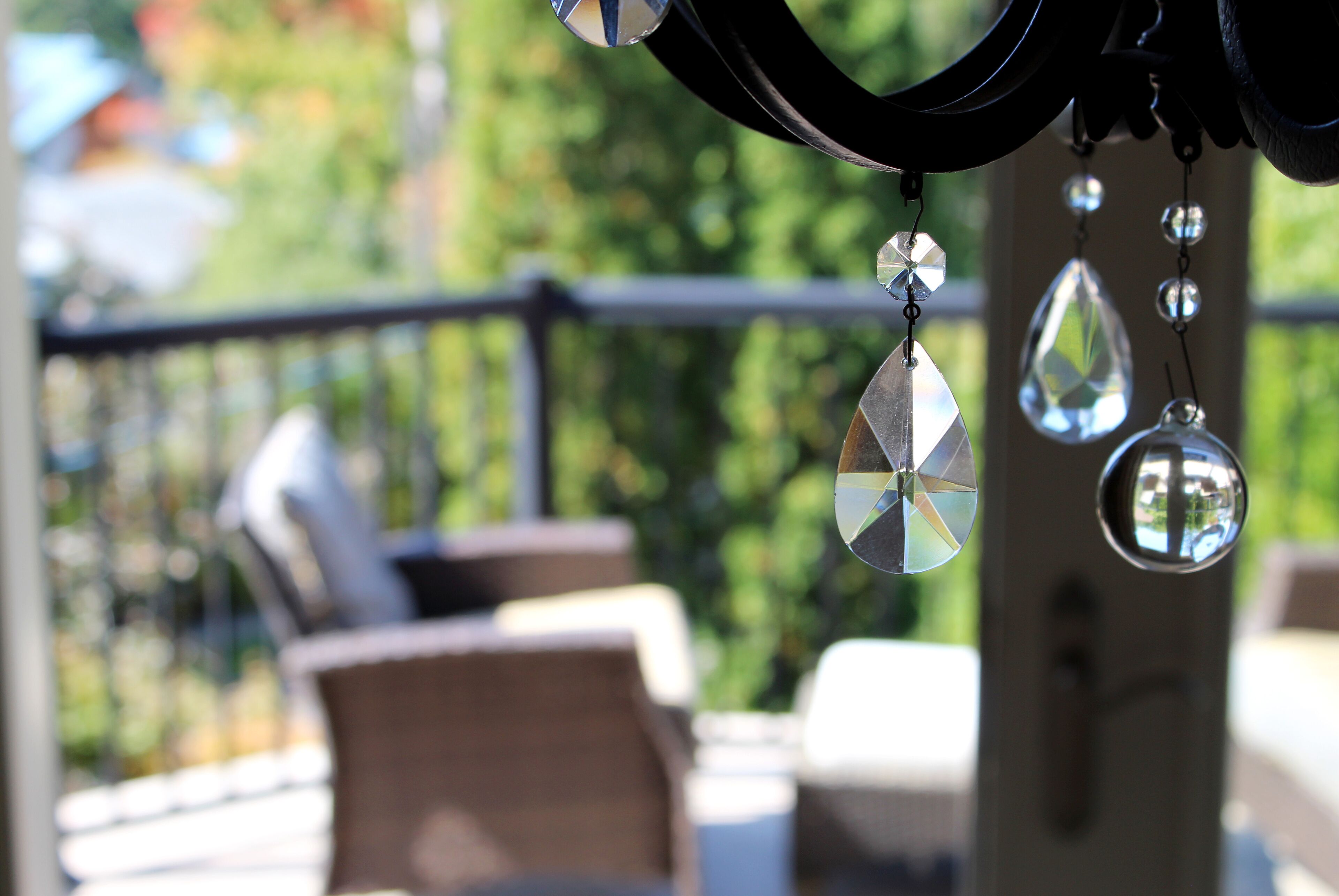 A patio area with outdoor furniture and hanging decorative elements.