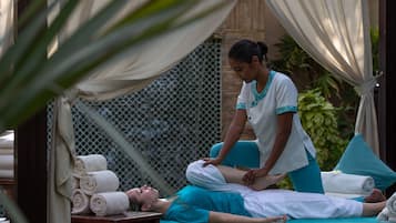 Experience a serene massage in a peaceful environment surrounded by lush greenery.