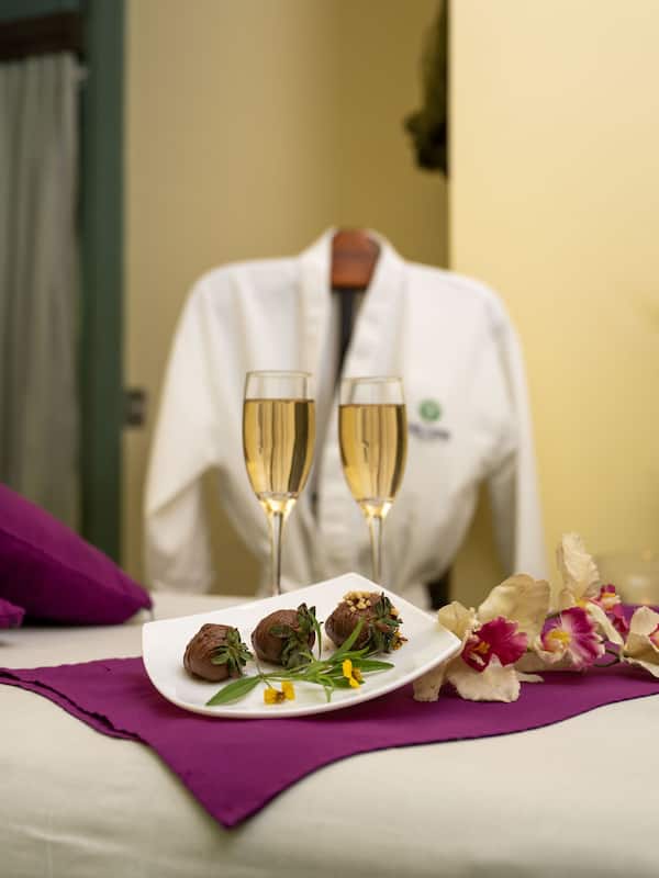 Relax in a stylishly appointed room with a plush bed, decorative plate, and potted plant.