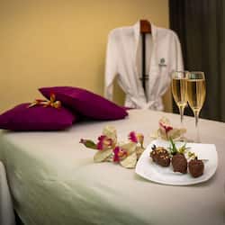 Relax in this serene retreat with a plush bed, wine, chocolates, and fresh flowers.