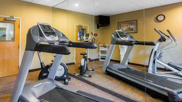 A fitness center with treadmills, a stationary bike, and a wall-mounted television.