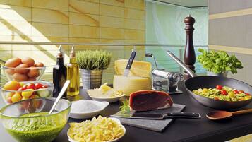 A kitchen counter with various food items and kitchen utensils.