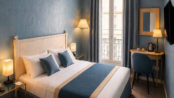A hotel room with a large bed, bedside lamps, a desk with a chair, a window with curtains, and a mounted television.