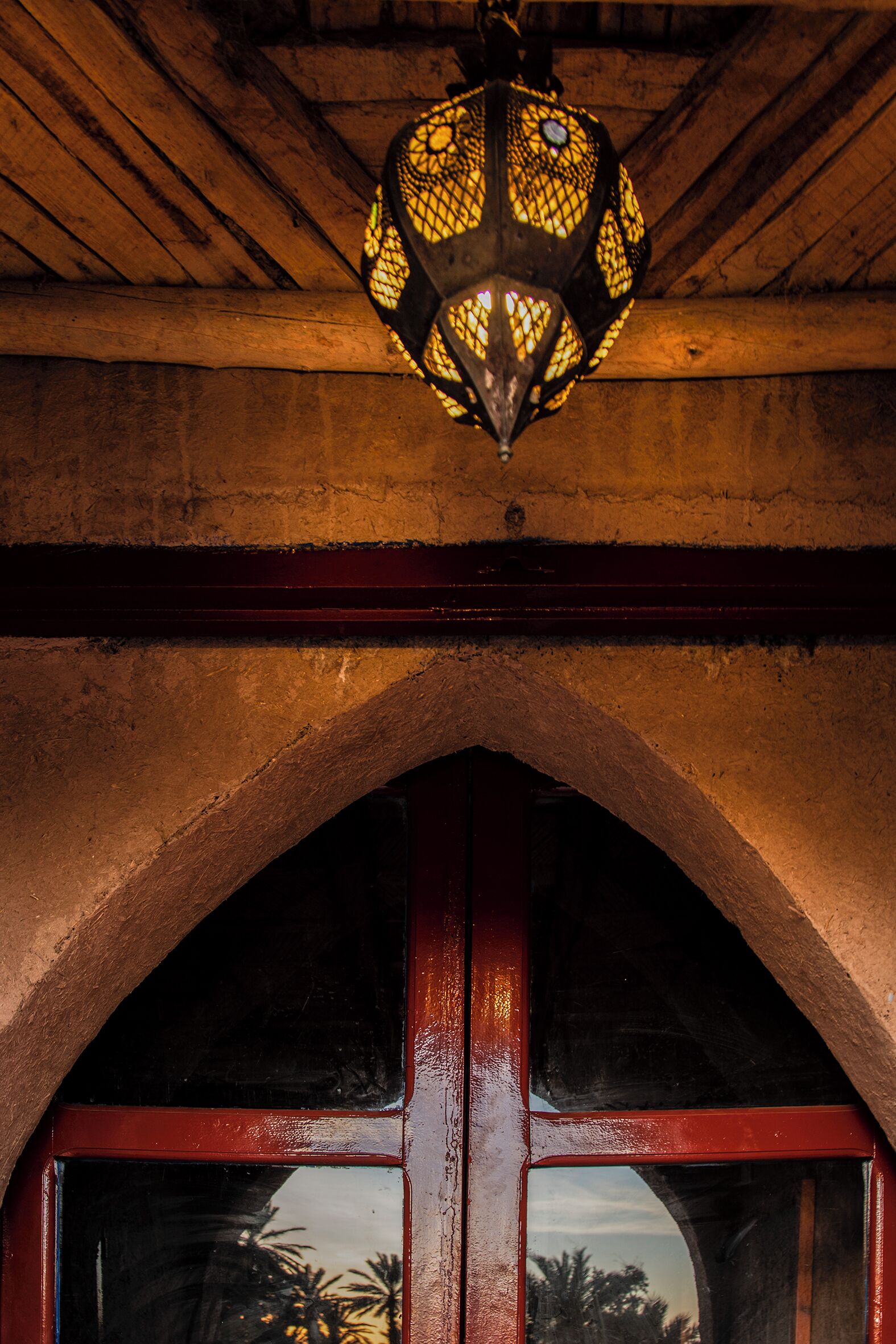 A wooden ceiling with a decorative hanging light fixture.