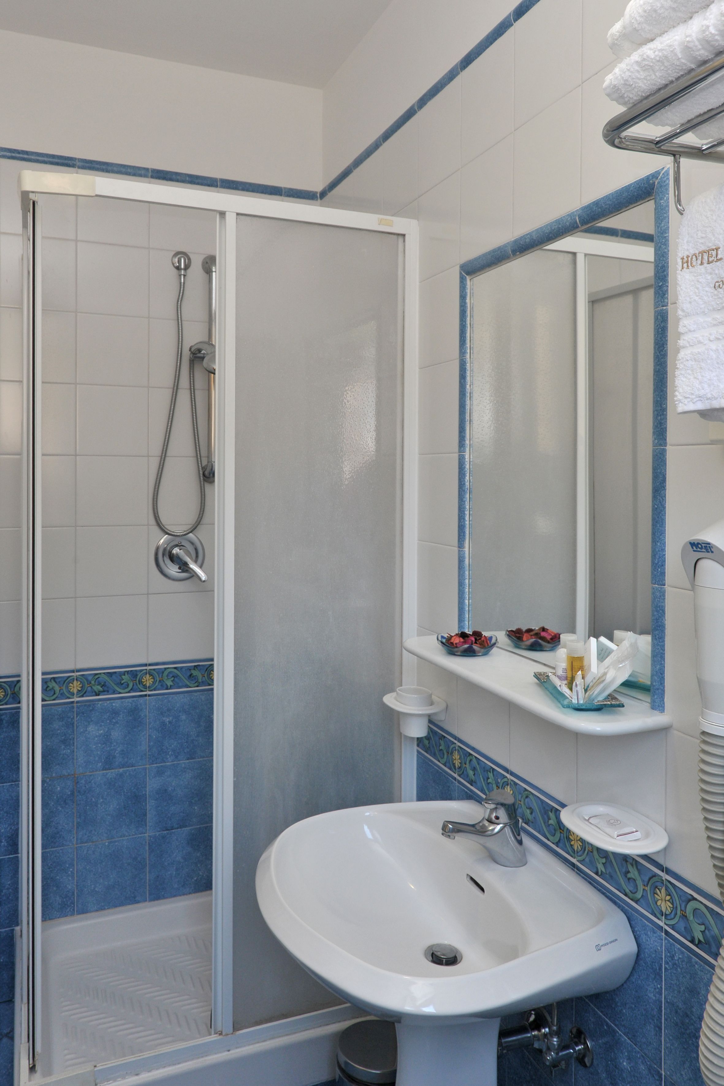 designer toiletries, hair dryer, bidet, towels