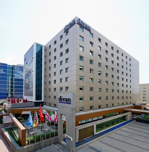 Un moderno edificio de hotel con un llamativo letrero que dice 'divan' en la fachada.