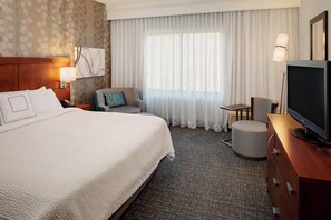 A hotel room with a large bed, a television, a desk, and a chair. - Courtyard by Marriott Pittsburgh West Homestead/Waterfront (Homestead)