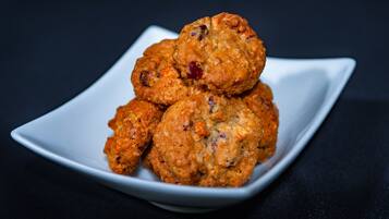 A stack of oatmeal cookies on a white square plate.