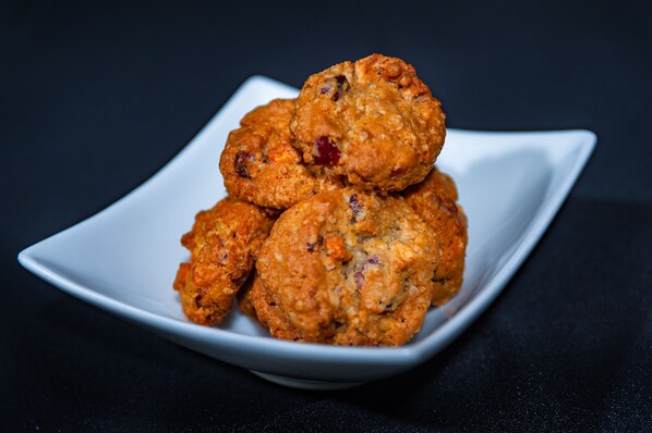 Un montón de galletas de avena sobre un plato cuadrado blanco.