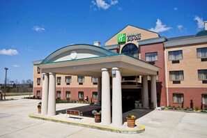 A Holiday Inn Express building with a covered entrance, columns, and a brick facade. - Holiday Inn Express Clanton by IHG (Clanton)