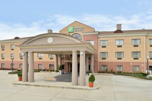 A Holiday Inn Express building with a covered entrance, multiple windows, and a brick facade.