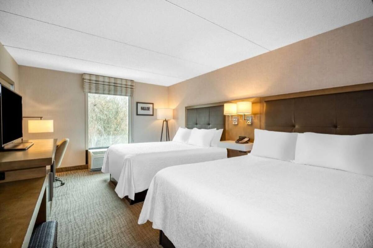 Premium bedding, desk, laptop workspace, blackout curtains