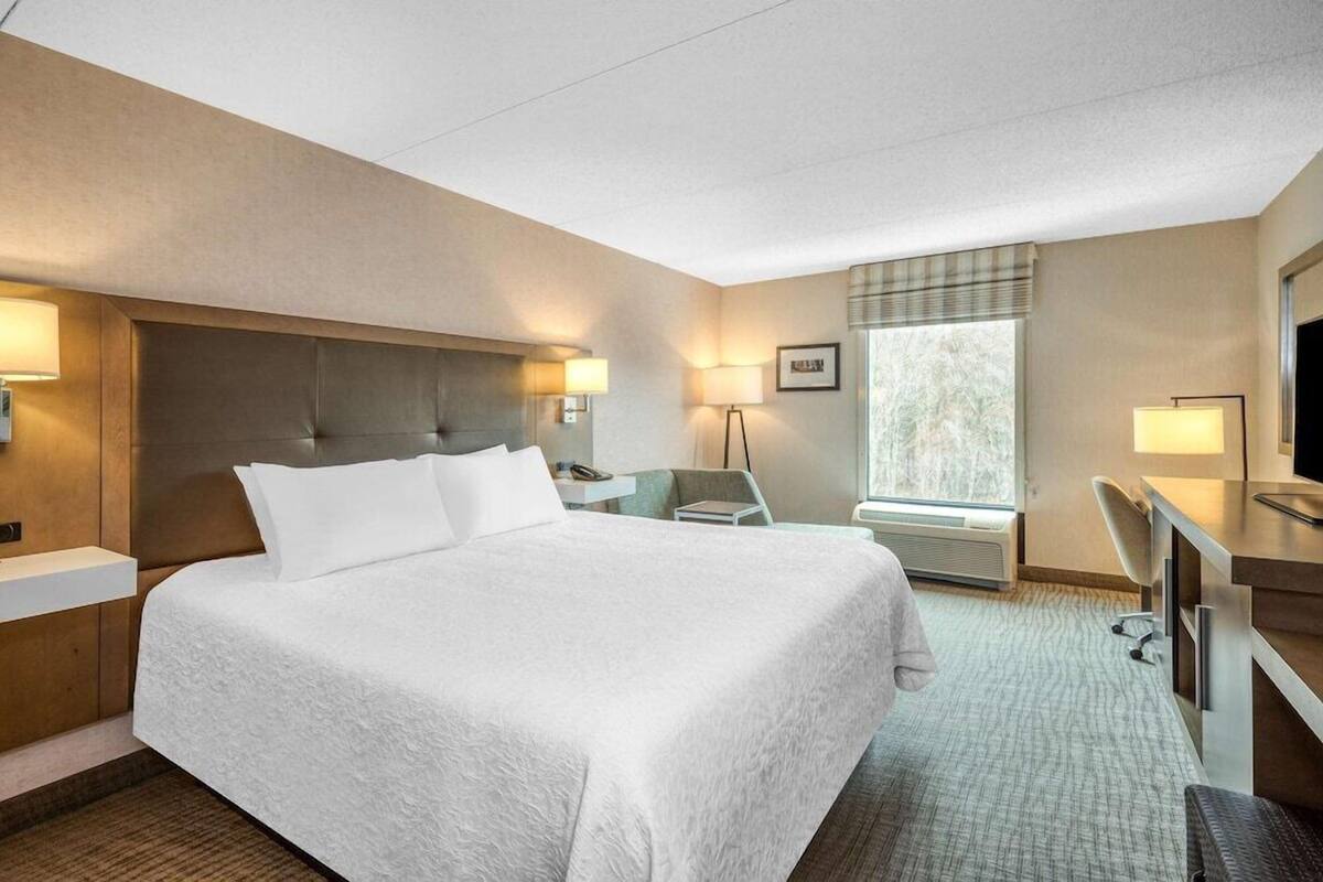 Premium bedding, desk, laptop workspace, blackout curtains