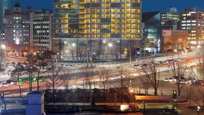 A high-rise hotel with a modern glass facade, multiple floors, and illuminated windows. - Park Hyatt Seoul (Seoul)