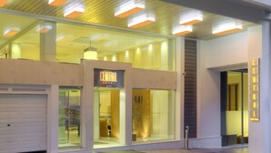 A modern hotel with large glass windows, a visible entrance, and a sign indicating the name. - Central Athens Hotel (Athens)