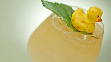 A cocktail with a rubber duck decoration.