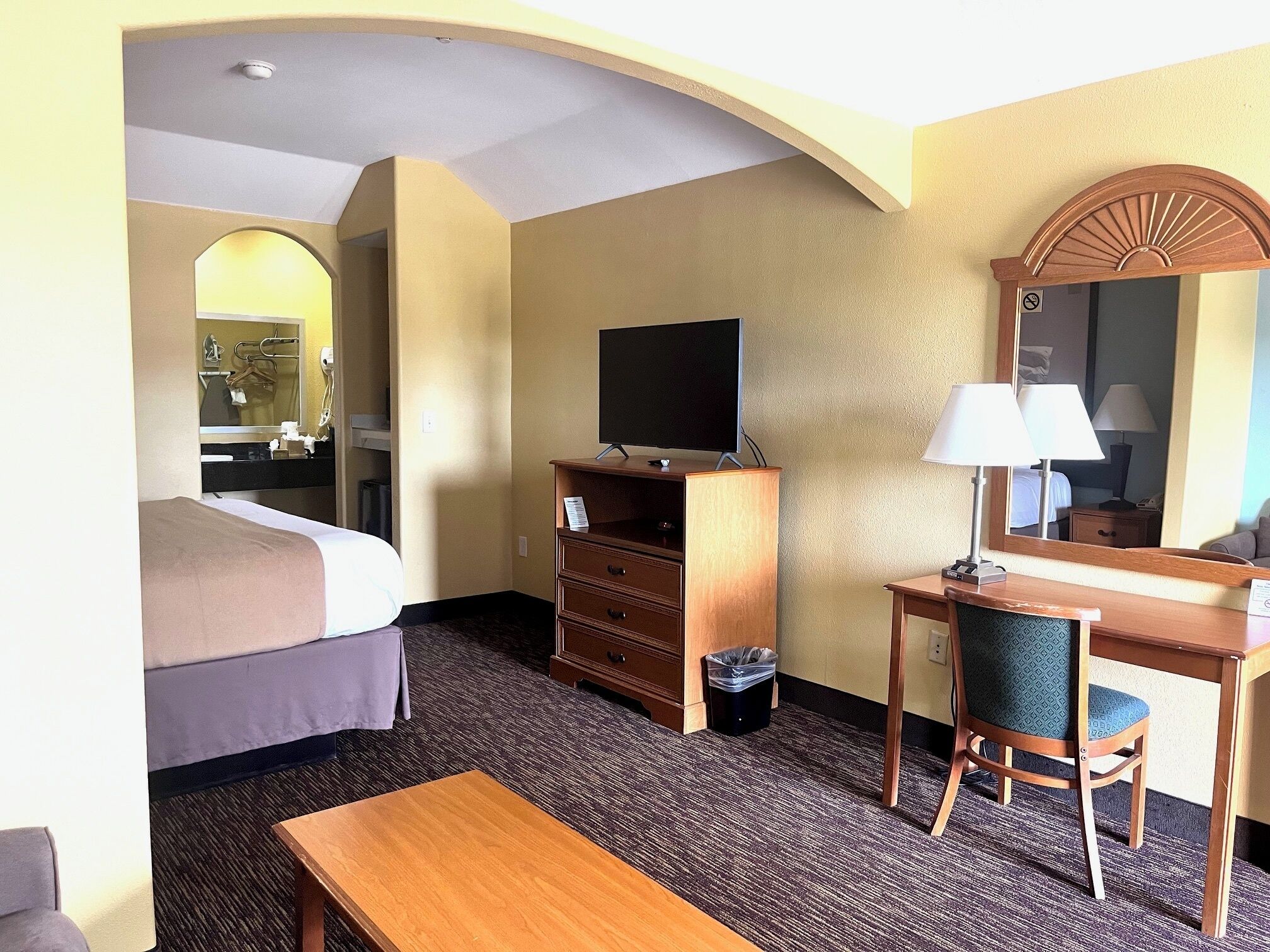 Desk, iron/ironing board, bed sheets, alarm clocks