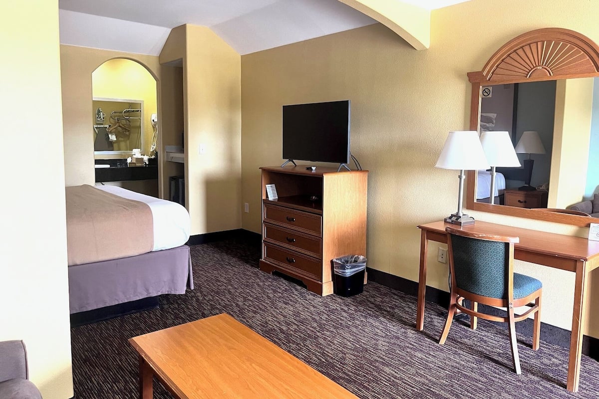 Desk, iron/ironing board, bed sheets, alarm clocks