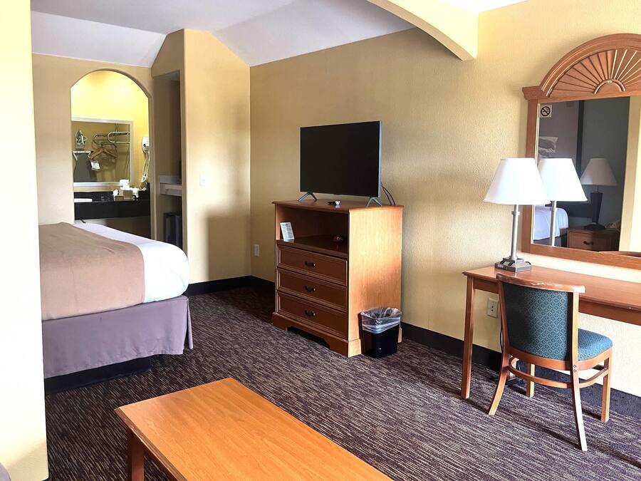 Desk, iron/ironing board, bed sheets, alarm clocks