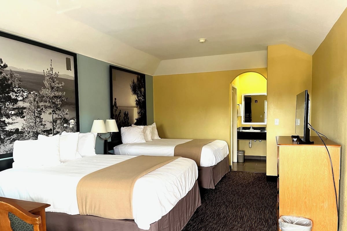 Desk, iron/ironing board, bed sheets, alarm clocks