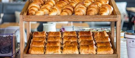 A bakery display with croissants and pastries.
