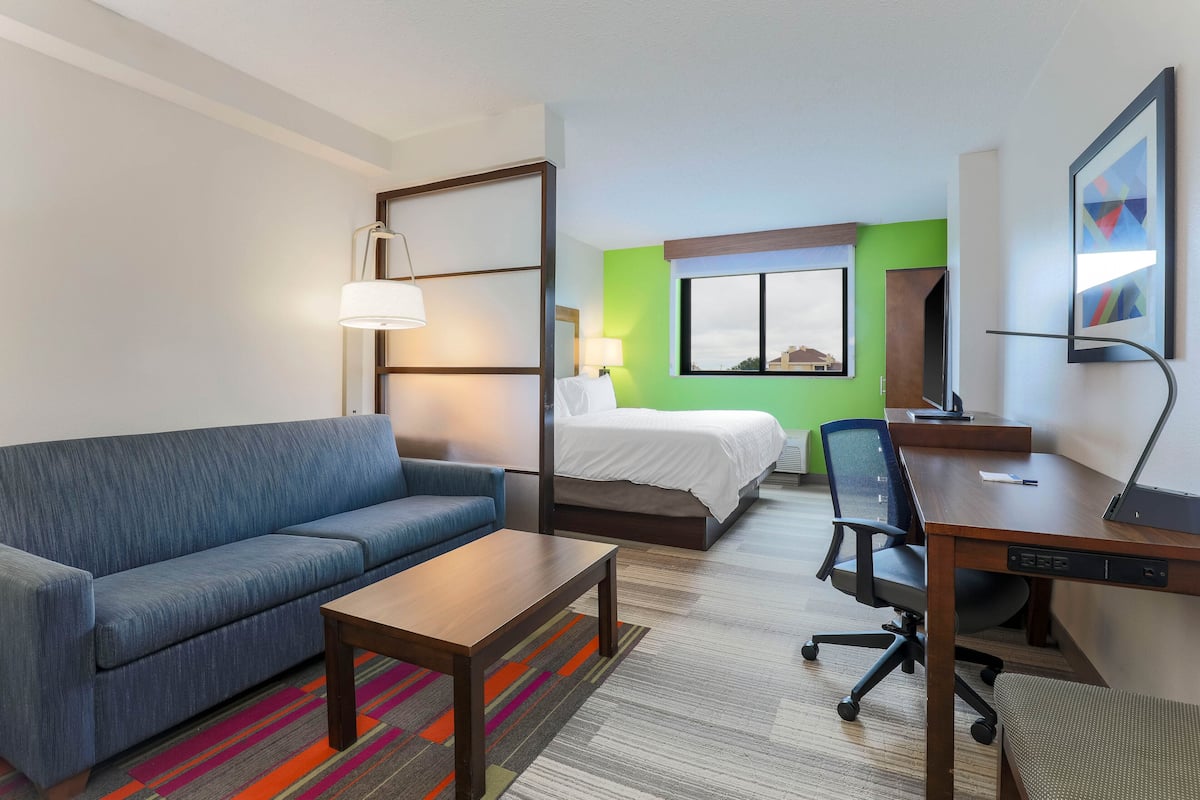 Premium bedding, desk, laptop workspace, blackout curtains